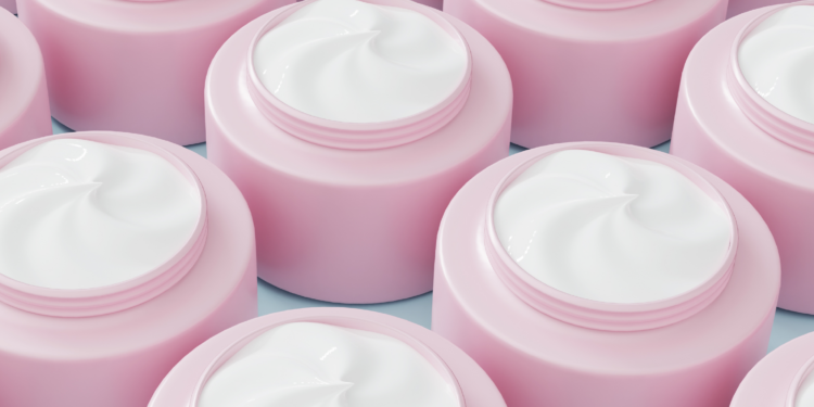 Rows of open pink skin-care jars filled with white cream, shown in close-up