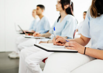 A group of nurses taking notes during a lecture at university.